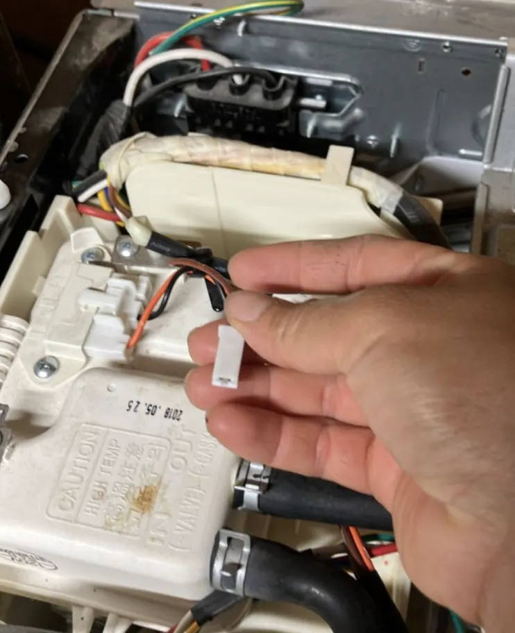 Close-up inspection of appliance ignition wiring and connectors